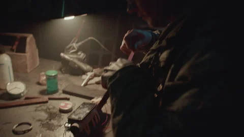 Face of a Bomb maker finishing an explosive device 스톡 동영상 256000904