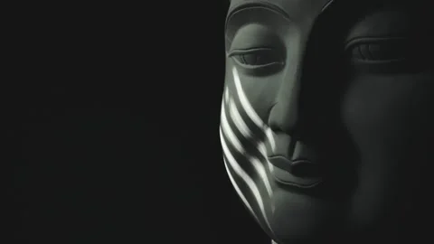 The face of the Buddha statue is illuminated by flickering light Stock Footage 334987177