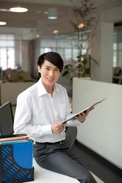 Face the camera. Vertical composition Manager Folder Staff Young men Confidence Stock Photos