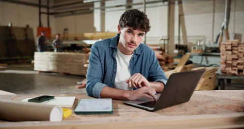 Face, carpenter and laptop with man in workshop for contractor, woodworking Video stock 338315545