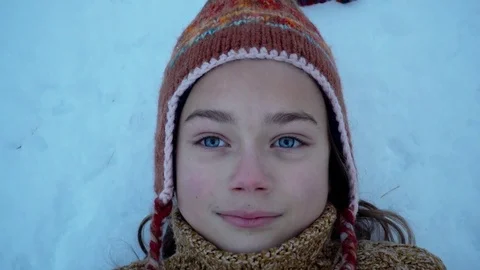 The face of the child lying head on the snow. Stock Footage 83388996