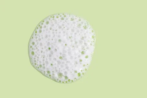 Face cleansing mousse texture on green background Stock Photos