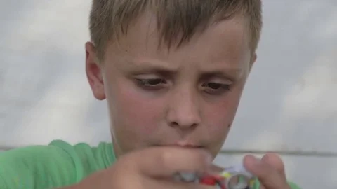 Face close up of a child playing with a spinner. Stock Footage 77061283