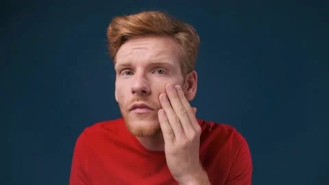 Face close up of a young ginger man looking at his skin problems examining his Vídeo Stock 200248021