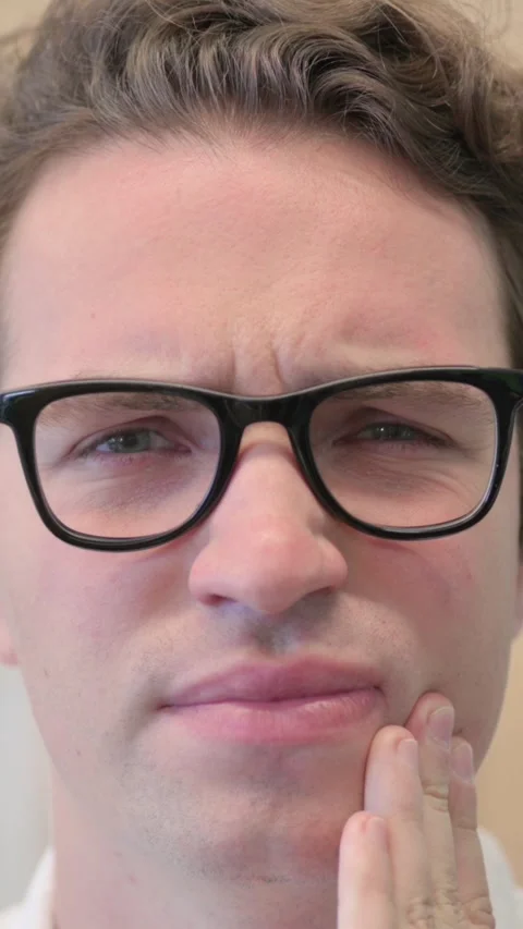Face Close Up of Young Man Having Toothache, Vertical Video Stock Footage 340034204