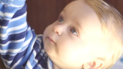 Face closeup of active 9-10 months old baby boy Stock Footage 82650082