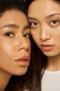 Face closeup of two beautiful mixed race young women with perfect glowing skin Foto stock