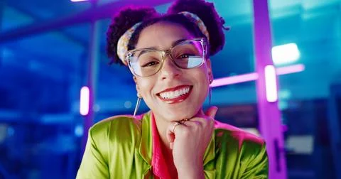 Face, computer and neon with programmer woman in office at night for coding or Stock Photos