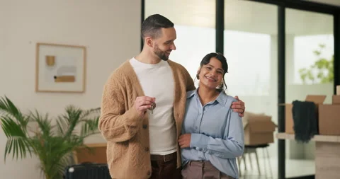 Face, couple and hug with keys to new home for property purchase, moving in and Stock Footage 335264587