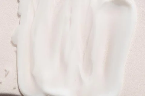 Face cream texture on white surface Stock Photos