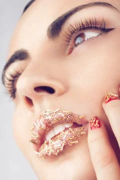 Face with creative lips with little keys makeup Stock Photos