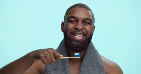 Face, dental toothpaste or man in studio on blue background for smile, wellness Stock Footage 308507734