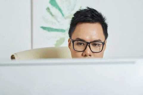 Face of designer checking his work on computer screen 库存照片
