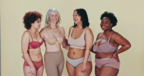 Diverse group of women in underwear, laughing together Stock Photo