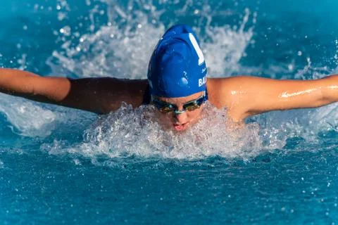 Face down technique during swim race. Stock Photos