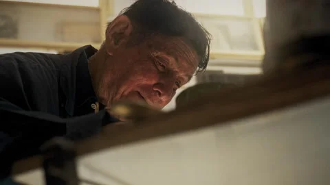 Face of An Elderly painter and his work in a studio Stock Footage 275298491