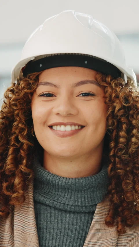 Face, engineer and woman in office with helmet, smile and pride for commercial Stock Footage 343709783
