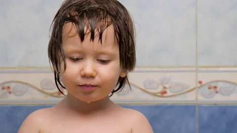 Face expression concept. Girl looking at the camera. Wet skin of kid after a 動画素材 131378676