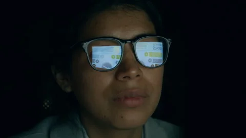 Face of Female Manager Analyzing Report Reflecting in her Glasses in Dark Office Stock Footage 331861776
