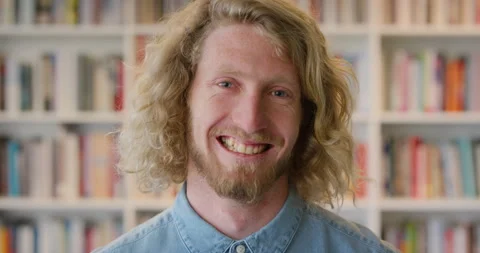 Face, funny and man in library for education, university professor and Stock Footage 336644127