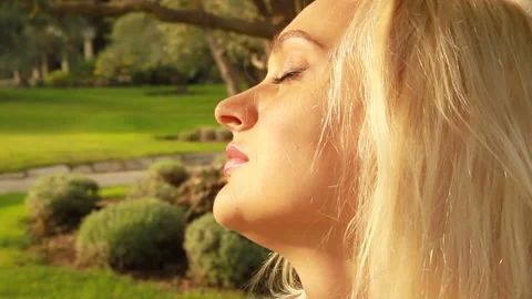 Face of a girl with closed eyes in the sun Stock Footage 86127553