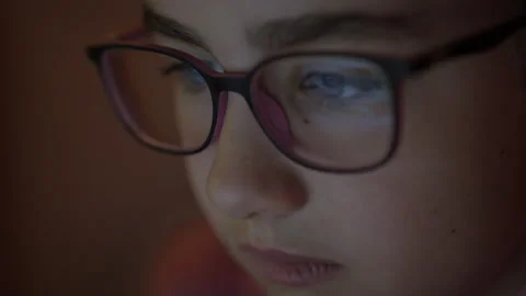 Face Girl is Looking at Digital Tablet Computer Screen With Glasses. Child .. Stock Footage 327602336