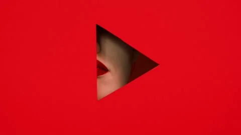 Face of girl in triangular hole red background. Stock Footage 86567204