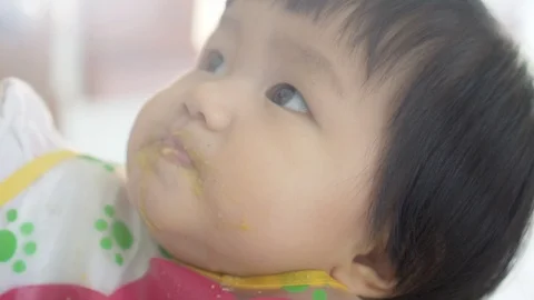 Face girl while her playing on dinner chair Stock Footage 94979012