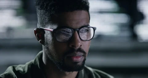Face, glasses and database with a man programming working in a dark office for Stock Footage 241889016