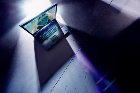 Face of hacker glowing on screen of laptop computer Stock Photos