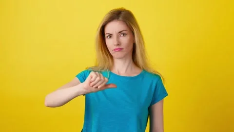 Face, hand and thumbs down by woman for negative, feedback or review, finger dow Stock Footage 242105073
