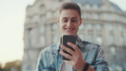 Face handsome young man use phone walking at old city street. Smiling at Stock Footage 146758468