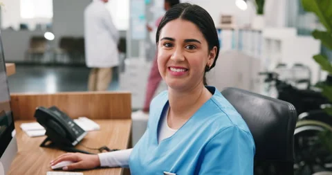 Face, happy and receptionist by computer in hospital for administration duty Stock Footage 346273819