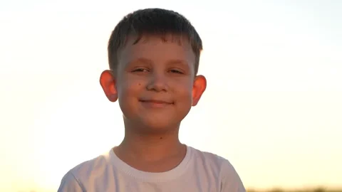Face happy boy close-up sunset. child kid son smiling. childhood dream happy boy Stock Footage 246686359