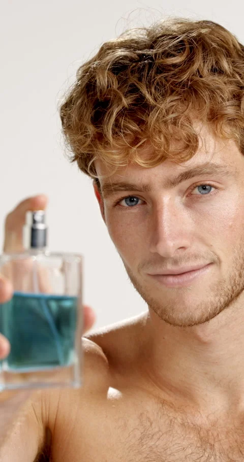 Face, happy man and spray perfume in studio for fragrance, hygiene and fresh Stock-Footage 312401699