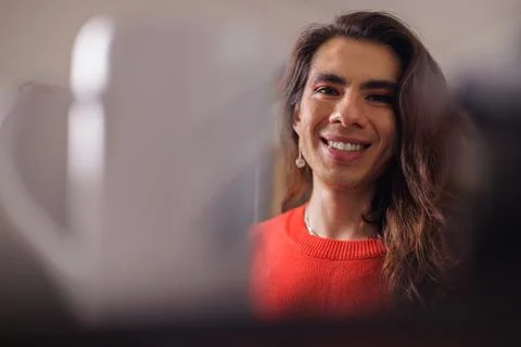 Face of happy non-binary person while doing their job looking at camera Stock Photos