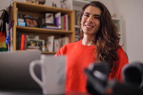 Face of happy non-binary person while doing their job looking at camera Stock Photos