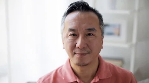 Face of happy smiling asian man at home Stock Footage