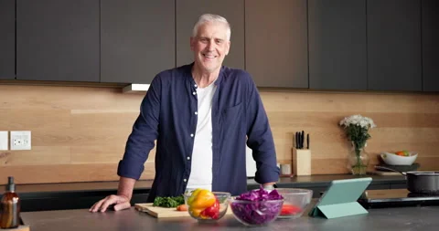 Face, home and old man with vegetables, cooking and confidence with tablet, Stock Footage 336857733