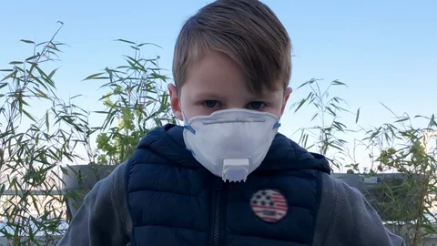Face ill boy in mask look at camera closeup. Infection coronavirus covid-19 4K. Stock Footage 127718547