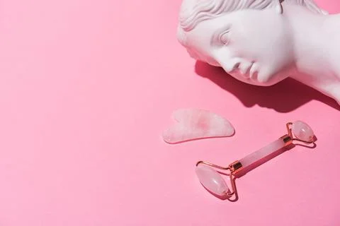 Face jade stone rollers and gua sha massage for trendy Venus plaster head Stock Photos