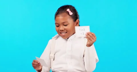 Face, learning math and girl with cards in studio isolated on a blue background Stock Footage 244986124