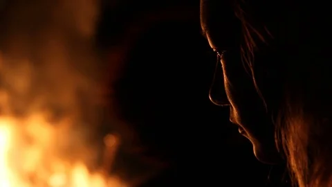 A face lit up by fire Stock Footage 122355439