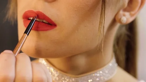 Face make-up. Close-up shot of young woman applying red lipstick on her lips. 4K Stock Footage 80439238