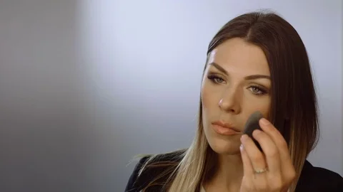 Face make-up. Young beautiful dark woman is making herself up in the boudoir. 4K Stock Footage 80830077