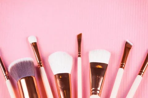 Face makeup brushes on pink background. Stock Photos