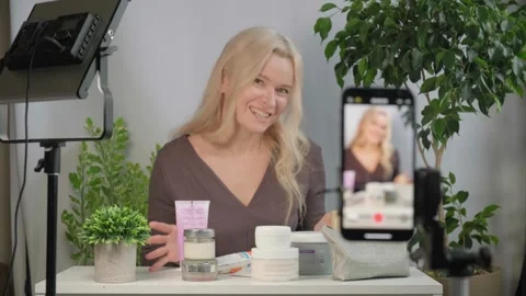 Face, makeup influencer or vlog with girl, spray or advice with content creator Stock Footage 320358550