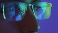 The face of the male in glasses looking on the display 4k or 4k+ Resolution