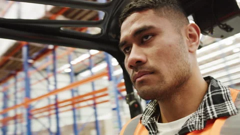 Face of a male worker in the warehouse using a forklift to move products Stock Footage 264082770