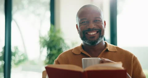 Face, man and book in home with coffee cup, relax and happiness with peace in Stock Footage 337756282